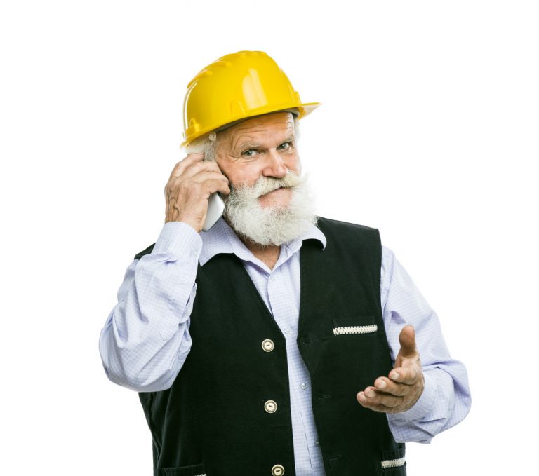 Senior manual worker with mobile phone isolated